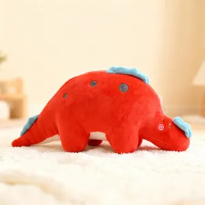 Close-up of a cute red cartoon dinosaur plush toy with soft blue spikes and cozy stuffing.