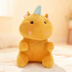 Detailed close-up shot of yellow unicorn hippo plush toy, soft stuffed animal doll for kids.