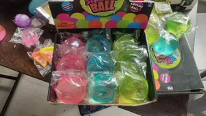 Colorful transparent crystal stress relief ball detail view, sensory squishy toy set in box.