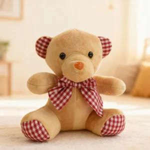 Cute plush teddy bear toy with red checkered bow tie and ear details, soft stuffed doll.