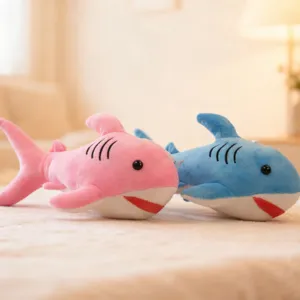 Cute cartoon shark plush toys, soft stuffed animals in pink and blue, perfect for kids.