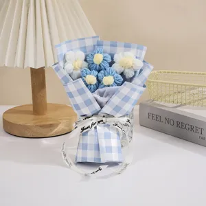 Handmade knitted flower bouquet with blue checkered wrapping paper and sweet ribbon gift.