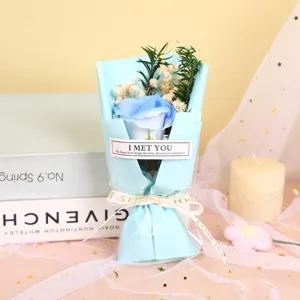 Detailed view of exquisite blue soap rose bouquet with dry baby breath and decorative ribbon.