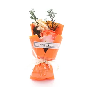 Mini soap rose and dried gypsophila bouquet in orange wrapping, perfect Valentine gift.