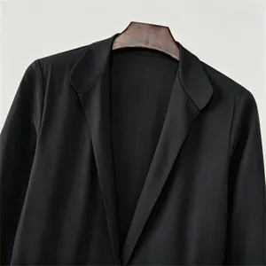 Close-up detail of a black long suit jacket lapel, elegant formal wear outerwear piece.