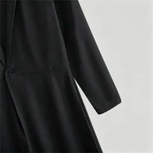 Black long coat detail view, single button waist-cinching design, elegant apparel close up.