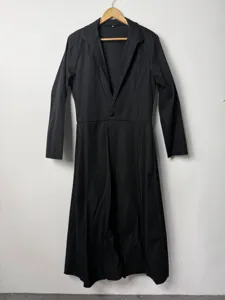 Men long black suit coat detail view, lapel collar single button waist design for banquet.