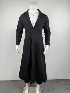 Detail view of the black long suit coat, featuring a stand collar and single button design.