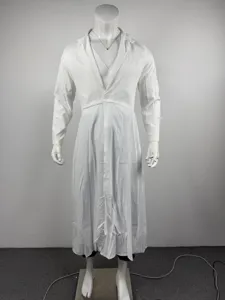 Detailed view of white long suit coat with lapel, cinched waist, and flared design.