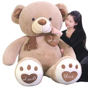 Giant plush teddy bear toy with scarf and heart pillow, soft hugging doll gift for kids.