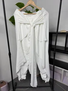 Men's white wrap harem pants with waist ties and layered draped details for casual wear.