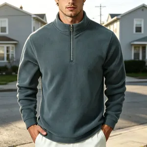 Detail view of men's quarter-zip fleece sweatshirt in dark teal with stand-up collar.