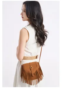 Detail view of the retro bohemian brown suede fringe crossbody bag with metal buckle and tassels.