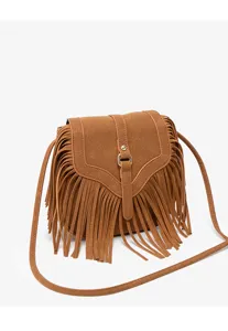 Close-up of the brown suede fringe crossbody bag, highlighting the delicate texture and straps.