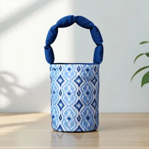 Detailed shot of ethnic style blue pattern bucket bag with puffed handle, fabric handbag.