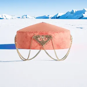 Detailed view of the traditional Kazakh ethnic pink flower hat with ornate gold chains and metallic decor.