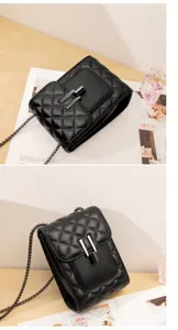 Detailed view of black quilted mini chain bag, elegant leather texture and metal lock.
