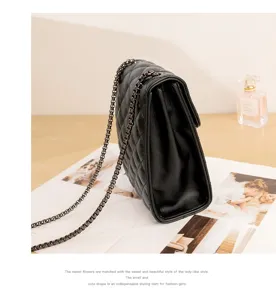 Black quilted chain shoulder bag detail view, classic flap design with metal strap for women.