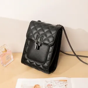 Black quilted mini crossbody bag with chain strap and metal lock. Stylish phone bag.