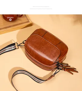 Detailed view of the vintage brown multi-compartment shoulder bag with stylish strap.