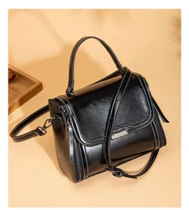 Retro black PU leather top-handle crossbody bag with contrast stitching and spacious interior.