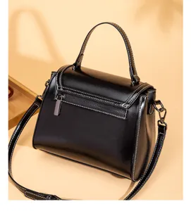 Black retro top-handle shoulder bag detail, elegant contrast stitching and spacious design.