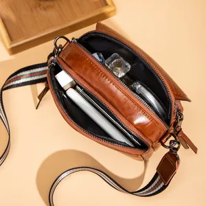 Classic brown multi-layer crossbody bag for women, retro casual shoulder bag with web strap.