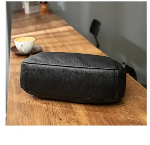Black litchi pattern leather shoulder bag detail shot, versatile minimalist commuter daily style.