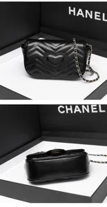 Detailed view of black quilted chain shoulder bag with heart pattern and metal strap.