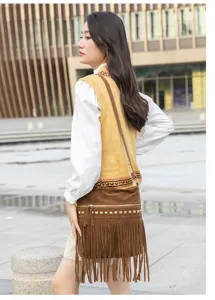 Brown suede fringe crossbody bag detail view, featuring metallic zippers and stylish studs.