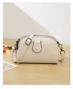 Detailed view of the stylish white double-layer crossbody bag with metallic hardware.