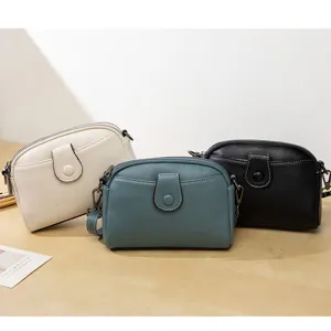 Minimalist solid color women's crossbody shoulder bag with multi-layer zipper and front buckle.