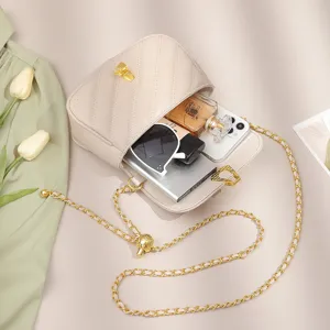 Beige quilted crossbody bag for women with gold chain strap, stylish shoulder bag daily use.