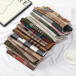Close-up view of classic plaid tassel scarves, soft winter warm fashion neck wrap.