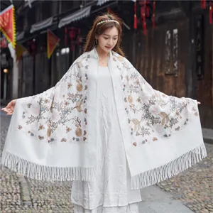 Detail view of ethnic embroidered cashmere-feel shawl, floral pattern, fringe accent for women.