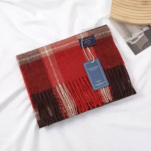 Detailed view of cozy winter plaid scarf with fringe tassels, soft texture for casual warmth.