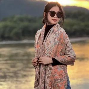 Detailed view of ethnic paisley fringe shawl, warm jacquard design for outdoor autumn wear.