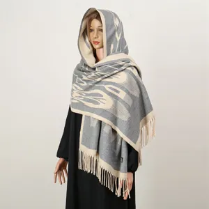 Ethnic style hooded scarf detail, grey and beige pattern with fringe, warm winter shawl.