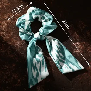 Xinjiang ethnic style teal scrunchie with long bow streamer, chic fabric hair accessory.