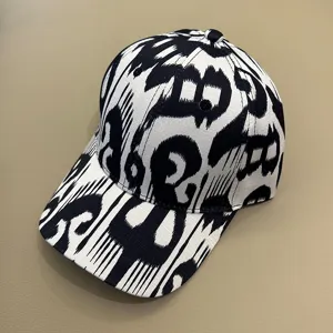 Close-up detail of the black and white ethnic print baseball cap showing clear texture.