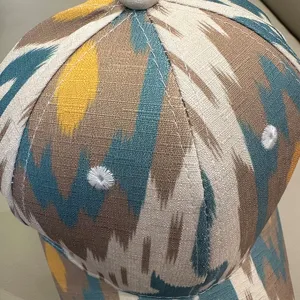 Ethnic style printed baseball cap detail, traditional ikat pattern, premium fabric sun protection visor.