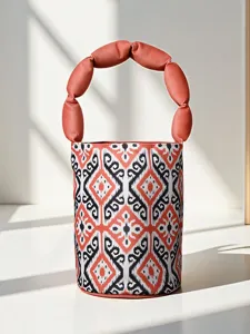 Ethnic style Atlas silk bucket bag with unique puffy handle, stylish Xinjiang cultural gift handbag.