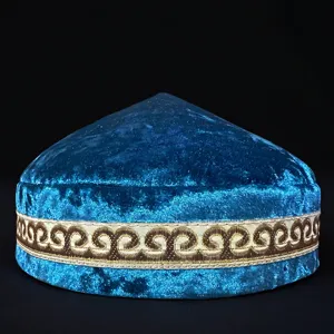 Detail view of a traditional Kazakh style blue velvet embroidered cap with intricate gold patterns.