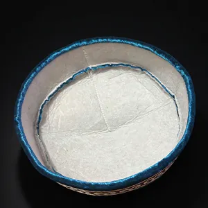 Traditional Kazakh embroidered round hat with blue metallic trim and detailed ethnic style pattern.