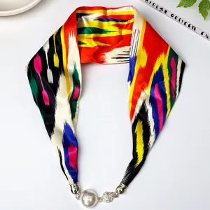 Elegant long silk scarf featuring vibrant ethnic patterns and a chic pearl magnetic clasp.