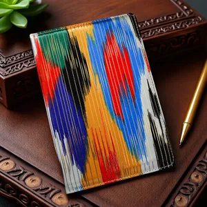 Detailed view of vibrant ethnic ikat pattern fabric notebook cover with traditional colorful vertical stripes.