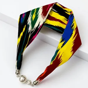 Colorful silk scarf necklace with magnetic pearl clasp and traditional ethnic print pattern.