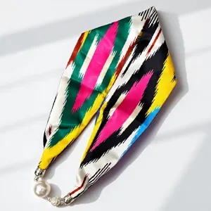Xinjiang Atlas silk scarf with magnetic pearl necklace clasp, vibrant ethnic striped design.