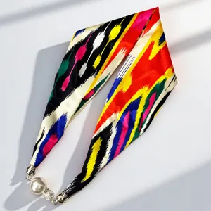 Xinjiang Atlas style silk scarf with magnetic pearl clasp, elegant long ribbon accessory.