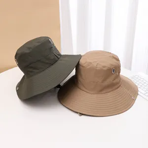 Quick-dry bucket hat for outdoor camping, hiking, and climbing with wide brim and chin strap.